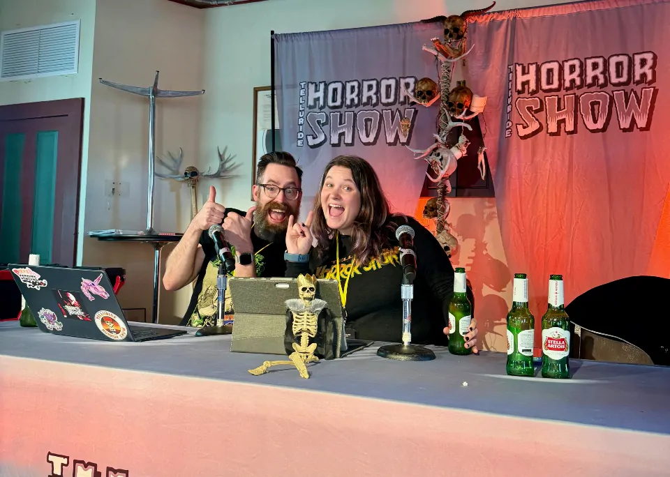 Brad McHargue and Becky Sayers smiling onstage at Telluride Horror Show's Fright or Wrong Trivia.