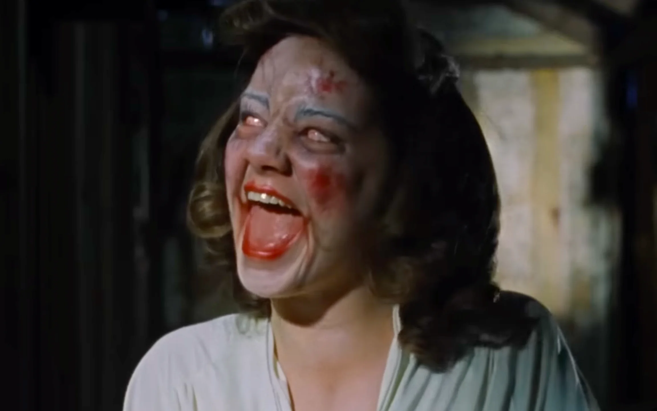 Linda won't stop laughing in Sam Raimi's 1981 horror classic EVIL DEAD (Credit: Ghosthouse Pictures)