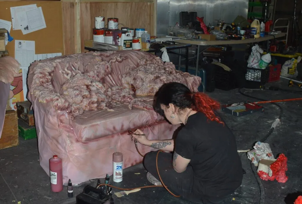 Makeup FX artist Beatrice Sniper works on furnishings for the "flesh apartment."