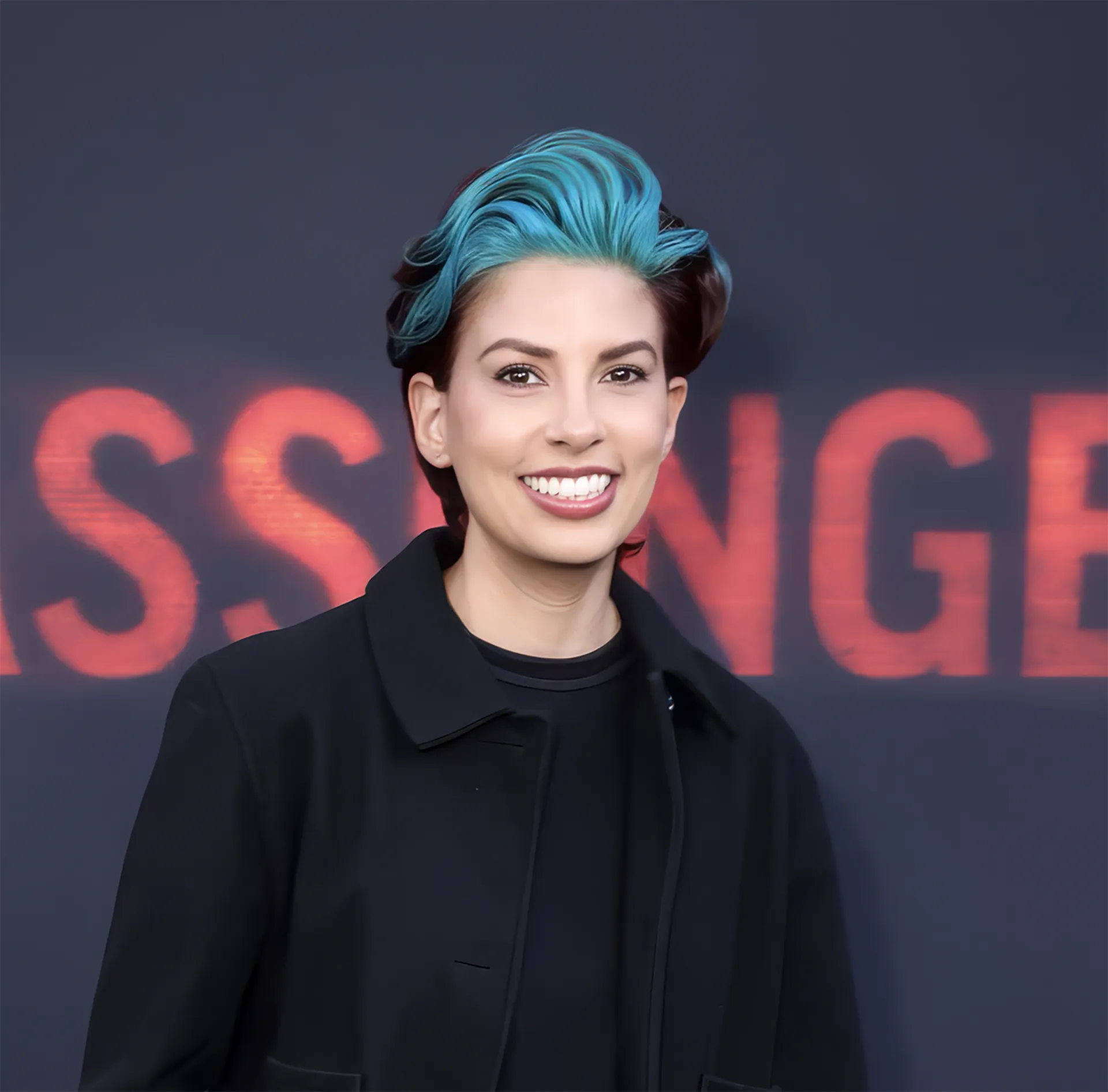 Angel Melanson, Director of Programming at Shudder in front of a step and repeat