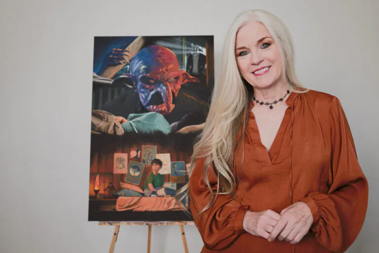 GOODBYE, MONSTER Poster artist JoAnne McGrath stands beside her work.