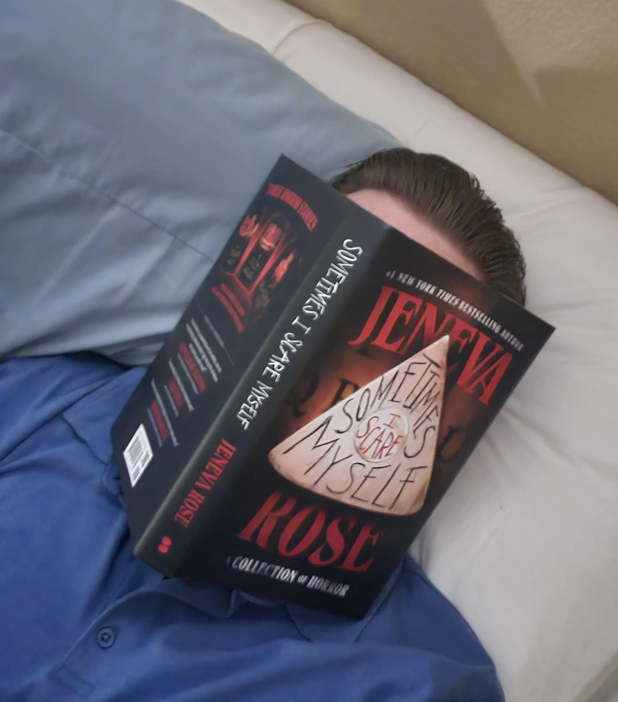 Fango Book Club member Allan Piper with a copy of Jeneva Rose's SOMETIMES I SCARE MYSELF over his face.